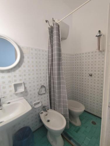 a bathroom with a sink and a toilet and a shower at Casa Pesce Rooms Rent in Serrara Fontana
