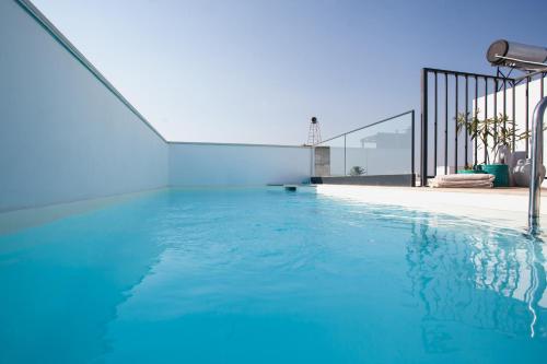 a swimming pool with blue water in a house at Mar-Ria 1 in Fuzeta