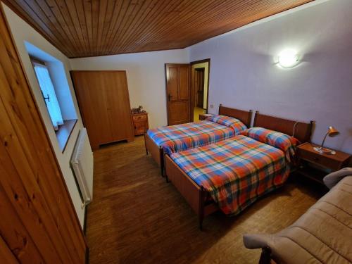 Postel nebo postele na pokoji v ubytování Chalet Nontiscordardime