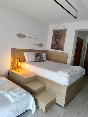 a bedroom with two beds and a lamp in it at Penthesileia Mare in Alexandroupoli
