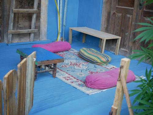 a room with pillows and a table on the floor at Mettavasi in Kutaisi