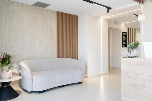 a living room with a chair and a table at Erdeti Boutique Hotel in Sarandë