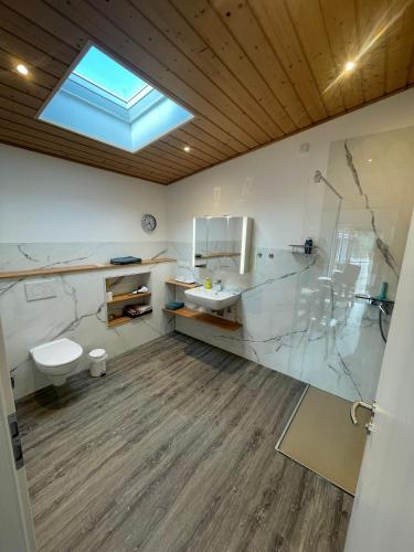 a bathroom with a sink and a toilet and a window at Kaminstube Hof Friebe in Reken