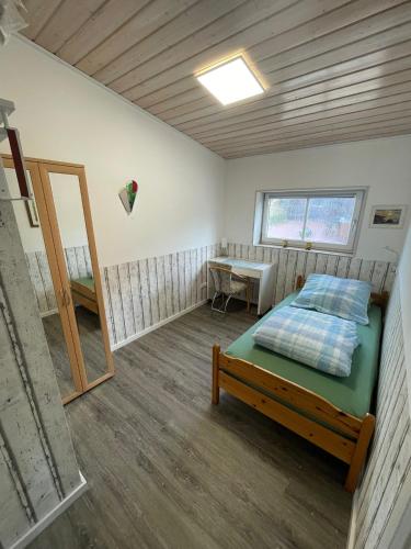 a room with a bed and a table in it at Kaminstube Hof Friebe in Reken