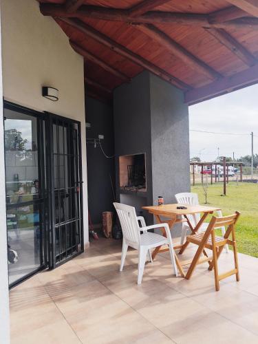 a patio with a wooden table and chairs at Ayres del Nautico in Pueblo Liebig