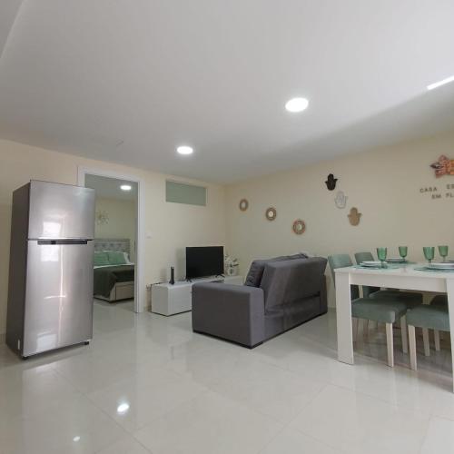 a living room with a couch and a refrigerator at Casa Estrela Em Flor in Covilhã
