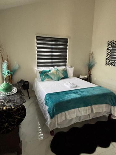 a bedroom with a large bed and a window at Cozy and Simple Escape in Kupuis