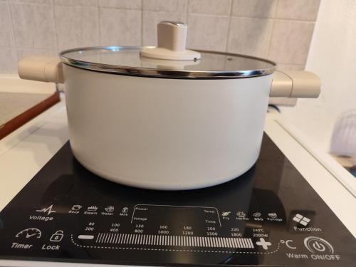 a large white pot sitting on top of a stove at Penthesileia Mare in Alexandroupoli