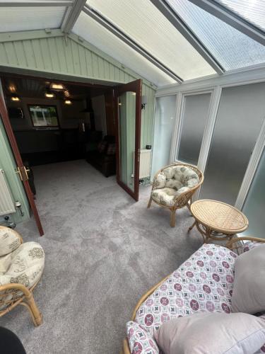 a living room with a couch and a table and chairs at Craiglea Cottage in Fort William