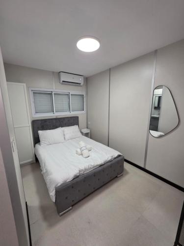 a small bedroom with a bed with a mirror at Ryo 42 Studio apartment 5 minutes from the beach in Bat Yam