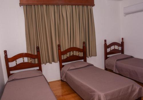 Ένα ή περισσότερα κρεβάτια σε δωμάτιο στο Hotel Obino São Borja
