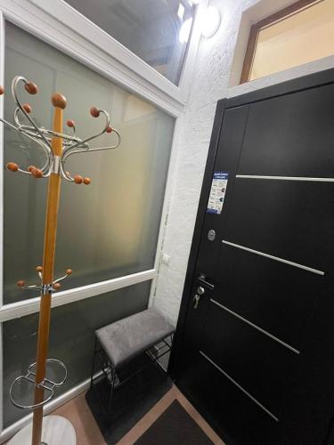a room with a door and a stool next to a door at Cozy apartment in the center in Khmelʼnytsʼkyy