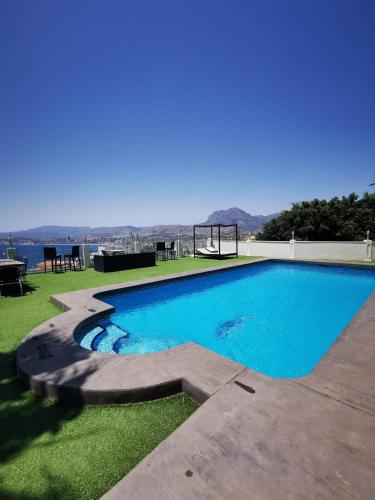 a swimming pool with a view of the water at Villa Hawai in Benidorm