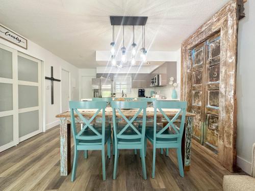a dining room with a blue table and chairs at Villa Valbuena Azul Escape 2 Kings Key Largo Pickleball Tennis Pool Lagoon in Key Largo