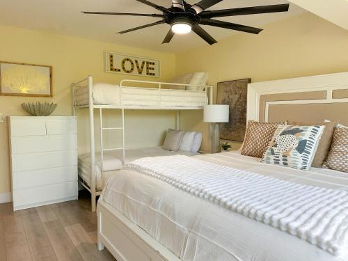 a bedroom with two bunk beds and a ceiling fan at Villa Valbuena Azul Escape 2 Kings Key Largo Pickleball Tennis Pool Lagoon in Key Largo