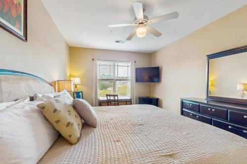 a bedroom with a bed and a ceiling fan at Friends Delight in Calabash