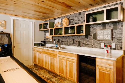a kitchen with a sink and a counter top at Cozy Mountain View Condo at Powderhorn Mountain in Bessemer