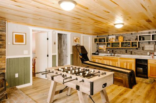 a large wooden foosball table in a kitchen at Cozy Mountain View Condo at Powderhorn Mountain in Bessemer