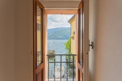 an open door with a view of the water at Il Porticciolo by Rent All Como in Carate Urio