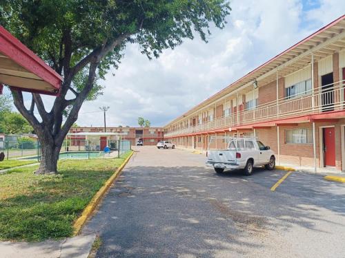 a white truck parked in front of a building at Pen Ann by Belvilla Pharr McAllen TX in Pharr