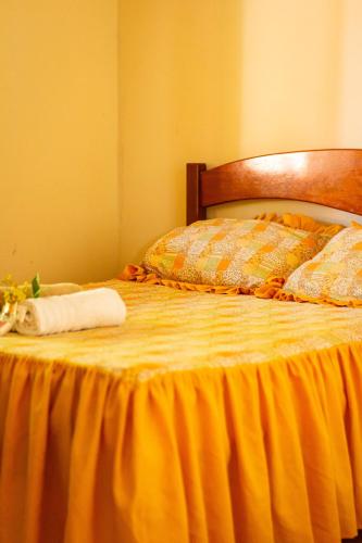 a bed with a towel on top of it at Casa de Hospedagem Cajueiro in Jijoca de Jericoacoara