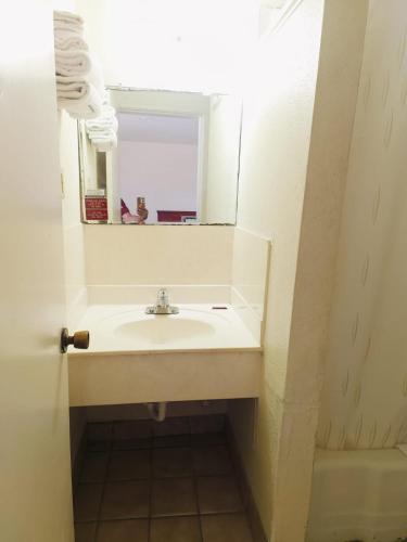 a bathroom with a sink and a mirror at Pen Ann by Belvilla Pharr McAllen TX in Pharr