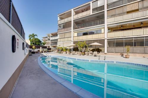 a swimming pool in front of a building at Centrally Located Kailua-Kona Condo with Lanai! in Kailua-Kona