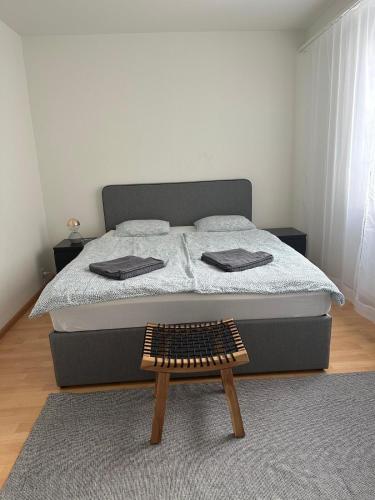 a bedroom with a bed with a wooden foot board at Business-Wohnung Messe Basel in Basel
