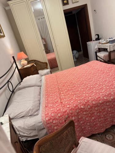 a bedroom with two beds and a mirror at Residence Della Corte in Tocco da Casauria