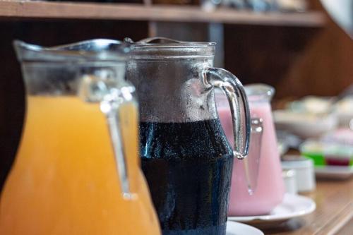 a glass pitcher of orange juice on a table at Pousada Vista Horizonte in Penha