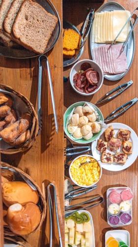 a table with many different types of food on it at Pousada Vista Horizonte in Penha
