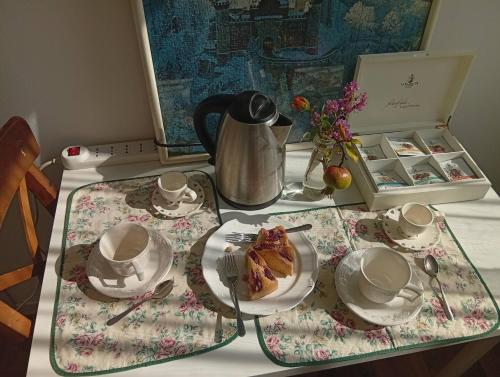a table with a plate of food and a tea set at La Casa di Cristina in Martellago