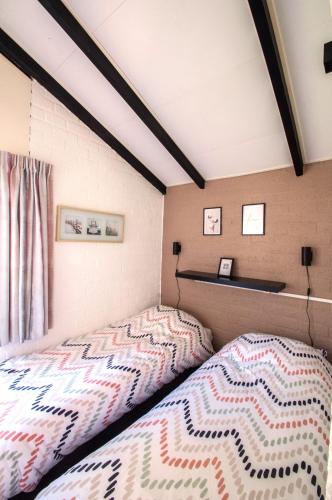 a bedroom with a bed and a window at Vakantiehuisje verhuur - Heuvel 35 in Simpelveld