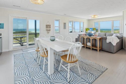 a living room with a table and chairs and a couch at 8720 - Beach Please (Frisco) in Frisco