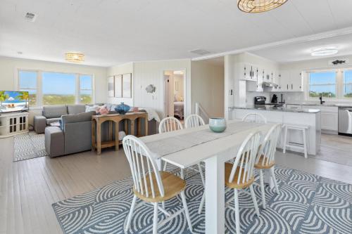a kitchen and living room with a table and chairs at 8720 - Beach Please (Frisco) in Frisco
