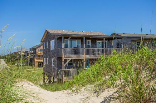 a house on top of a beach near the sand at 8720 - Beach Please (Frisco) in Frisco
