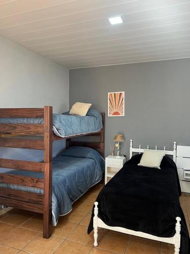 a bedroom with two bunk beds in a room at Deptos Los Alerces in General Villegas