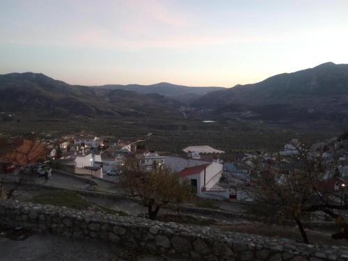 a view of a town with mountains in the background at Cueva El Madrono in Pegalajar