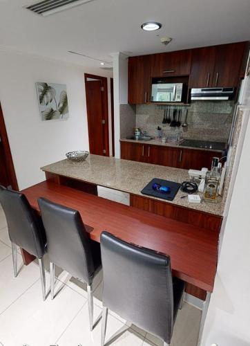 a kitchen with a counter with chairs around it at River view6 in Guayaquil