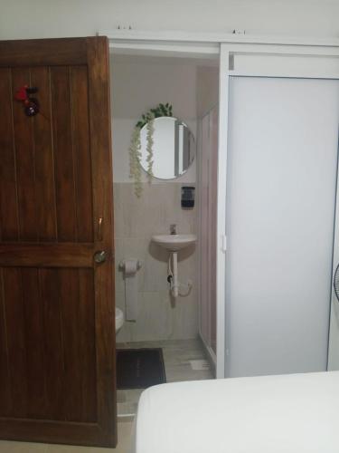 a bathroom with a sink and a mirror at KOKOA GARDEN INN in San Vicente de Chucurí