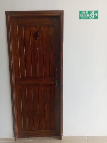 a wooden door in the corner of a room at KOKOA GARDEN INN in San Vicente de Chucurí
