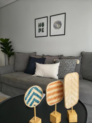 two chairs sitting on a table in front of a couch at The cozy seaside apartment in Nafpaktos