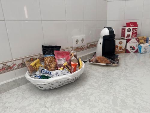 a basket of food sitting on a kitchen counter at Villa con Piscina climatizada in Sanlúcar de Barrameda
