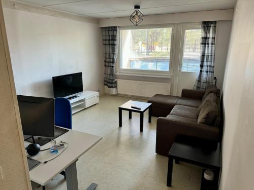 a living room with a couch and a table at Ground floor 3 bedroom apartment, free parking in Oulu