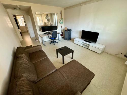 a living room with a couch and a flat screen tv at Ground floor 3 bedroom apartment, free parking in Oulu