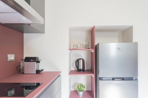 a kitchen with a refrigerator with the words love at Cernobbio Dream Suites by Rent All Como in Cernobbio