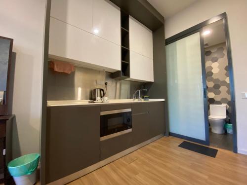 a small kitchen with a sink and a microwave at Ceylonz Suites by Stayla in Kuala Lumpur