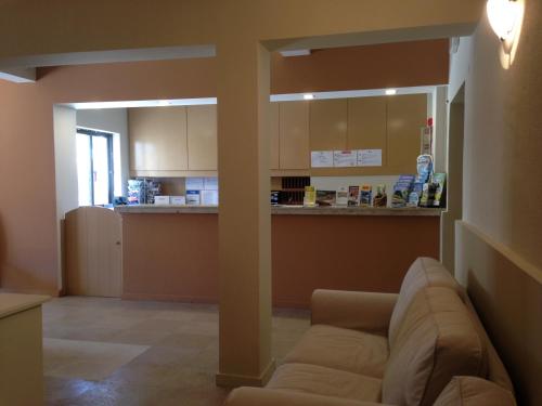 a living room with a couch and a kitchen at Vilamar in Luz