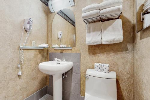 a bathroom with a sink and a toilet and a mirror at Shoshone 1917 in Big Sky