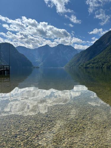 a large body of water with mountains in the background at Steinbock Apartement in Bad Goisern